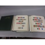 Three green New Age stamp albums containing a collection of British Commonwealth stamps