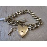 Heavy 9ct gold curb link bracelet with a 9ct gold working padlock clasp with key