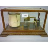 F. Darton and Co., early 20th Century gilt brass barograph housed in an oak and glazed cabinet