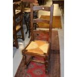 Set of six reproduction oak ladder back dining chairs with drop-in seats raised on turned supports