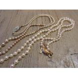 Graduated cultured pearl necklace with a 14ct gold clasp together with a simulated pearl necklace