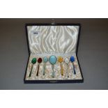 Set of six sterling silver gilt and coloured enamel coffee spoons, together with a matching sugar