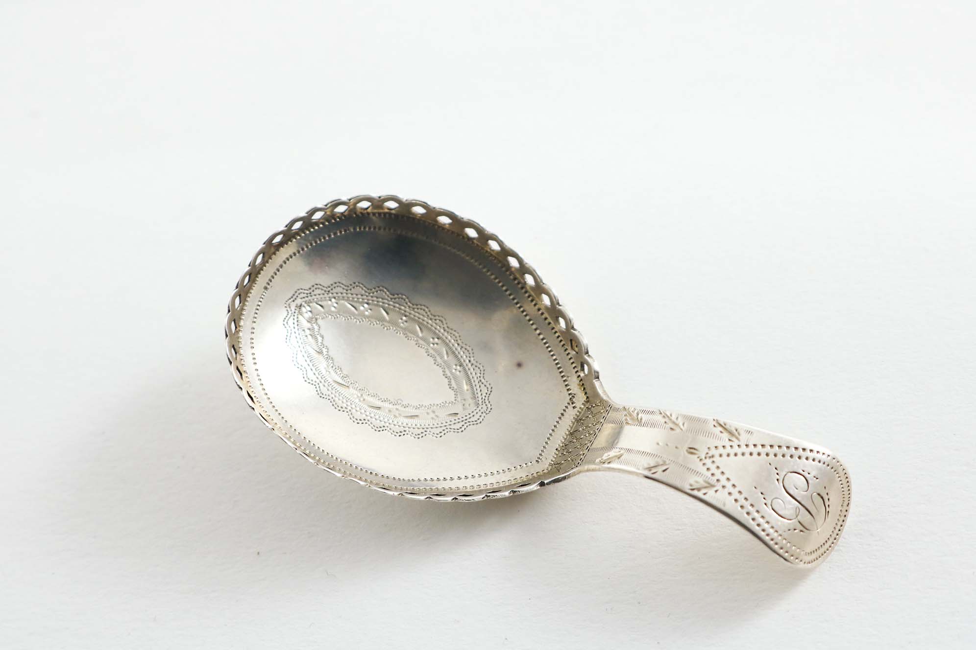 A GEORGE III ENGRAVED CADDY SPOON with a galleried bowl, initialled "B", by Cocks & Bettridge,