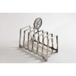 A LATE VICTORIAN ARTS & CRAFTS TOAST RACK with seven angular bars and a hammered finish, the