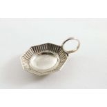 A GEORGE III CADDY SPOON with a ring handle and a small octagonal bowl with a stamped chevron