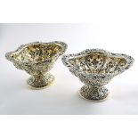 A MATCHED PAIR OF LATE VICTORIAN SILVERGILT BONBON DISHES on domed oval bases, with pierced &