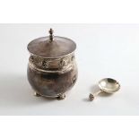 AN EARLY 20TH CENTURY SQUAT CIRCULAR TEA CADDY with a hammered finish, on four circular "seal"