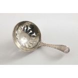 A GEORGE III ENGRAVED CADDY SPOON with a bright-cut stem & a pierced circular bowl, initialled, by