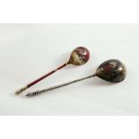 A LATE 19TH / EARLY 20TH CENTURY PARCELGILT SPOON with a turned finial, the back of the bowl cold-
