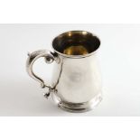A GEORGE II BALUSTER MUG with a spreading circular foot, a scroll handle & a gilt interior, by