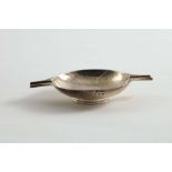 A SMALL ASH TRAY in the form of a quaich with a hammered finish, by William Robb of Ballater, with