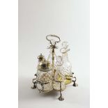 A GEORGE II WARWICK CRUET FRAME by Samuel Wood, London 1736, fitted with five later faceted cut-