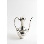 AN EARLY 20TH CENTURY AMERICAN COFFEE POT with a long slender neck and spout, floral scroll