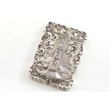 A VICTORIAN EMBOSSED "CASTLE TOP" CARD CASE of shaped rectangular outline with a scroll border & a