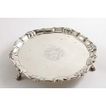 A GEORGE II SMALL SALVER of shaped circular outline with a shell and scroll border, engraved in