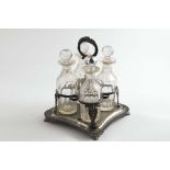 A GEORGE IV CRUET FRAME of shaped square outline with paw feet, a gadrooned border & a decorative