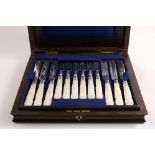 A VICTORIAN CASED SET OF TWELVE PAIRS OF DESSERT KNIVES & FORKS with carved, mother of pearl