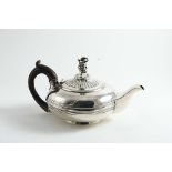 A GEORGE IV TEA POT of squat circular form with a reeded girdle around the centre and a rising,