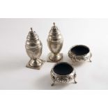 A PAIR OF GEORGE III VASE-SHAPED PEPPERETTES on square pedestal bases, with engraved decoration