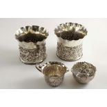 A PAIR OF LATE VICTORIAN EMBOSSED VASES OR PLANTERS with shaped and flaring rims, by William Comyns,