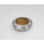 A GEORGE II SILVER MOUNTED HARDSTONE TOBACCO BOX oval with reeded borders and a pull-off cover,