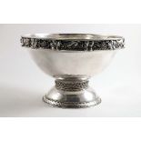 AN EARLY 20TH CENTURY HANDMADE CIRCULAR ROSE BOWL with a domed foot and a hammered finish, decorated