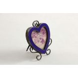 A LATE VICTORIAN MINIATURE HEART-SHAPED PHOTOGRAPH FRAME with an enamelled border, scroll