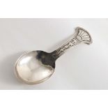 A LATE VICTORIAN HANDMADE CADDY SPOON the fan-shaped terminal chased with a stylised flower, by