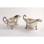 A PAIR OF MID 20TH CENTURY SAUCE BOATS with applied Celtic borders and zoomorphic handles & feet, by
