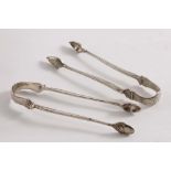 ARMS AT 90 DEGREES TO BOW:- Two pairs of George III sugar tongs with acorn bowls (one pair
