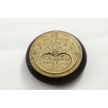 A 19TH CENTURY BRASS MOUNTED HARDWOOD "MISER'S" SNUFF BOX circular with a swivel aperture (to take a