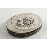 AN EDWARDIAN JEWELLERY OR DRESSING TABLE BOX of shallow oval form with a frieze of cherub masks