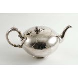 A VICTORIAN TEA POT of plain, squat circular form with a c-scroll handle and a fruit finial,