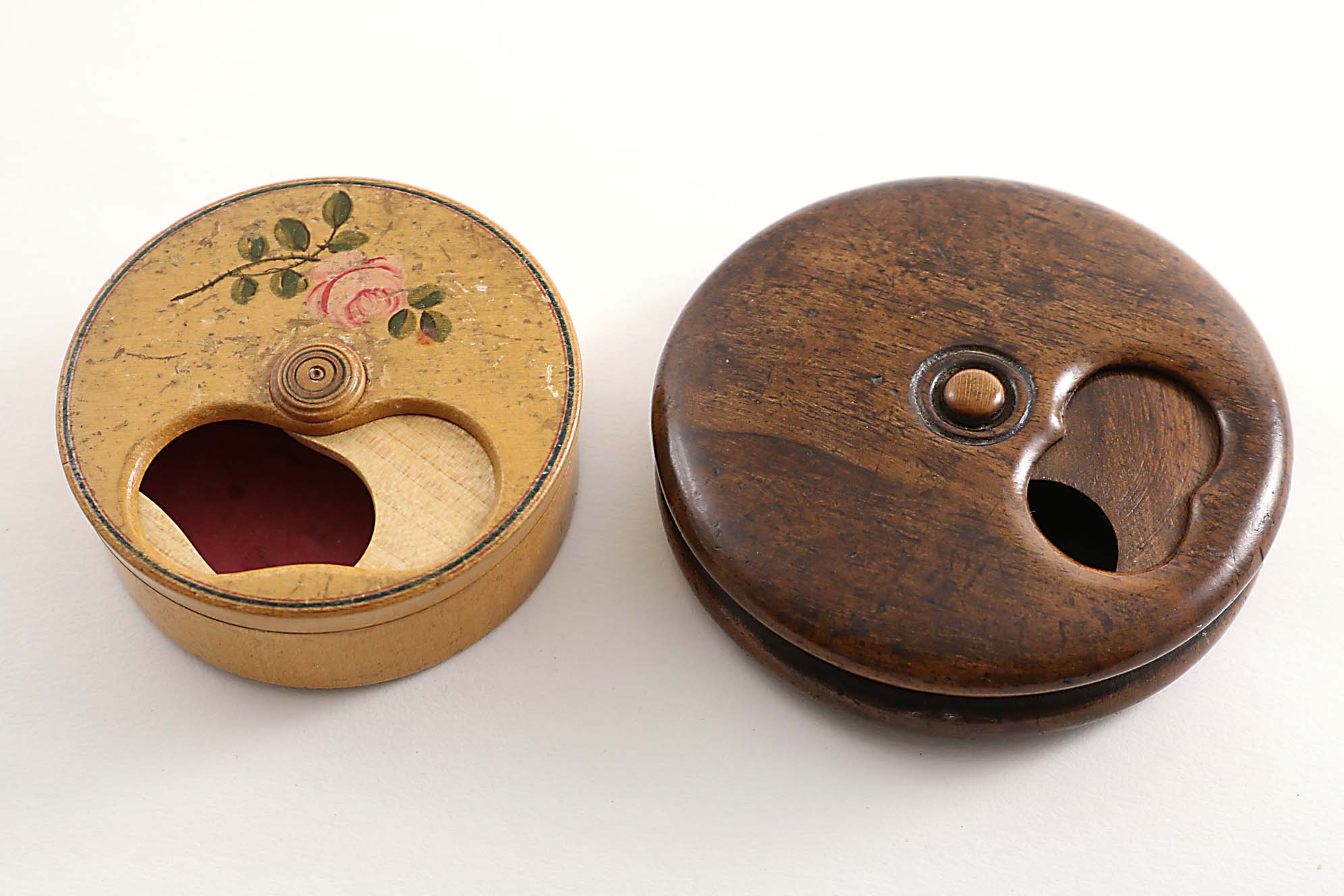 AN EARLY 19TH CENTURY CIRCULAR PALE WOODEN "MISER'S"SNUFF BOX painted with flowers (paper lining),