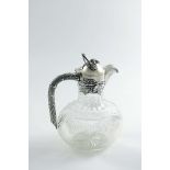 AN EARLY 20TH CENTURY GERMAN MOUNTED CUT-GLASS CLARET JUG with a rounded oval body, a bark-