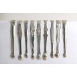 SHAPED ARMS:- Nine various pairs of George III sugar tongs with shaped arms, most also with