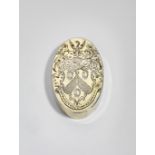 A GEORGE III SILVERGILT OVAL SNUFF BOX engraved on the cover with a coat of arms* and crest within