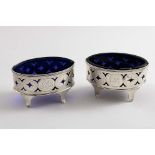 A PAIR OF GEORGE III ENGRAVED SALTS with navette-shaped bodies, pierced sides and four feet,