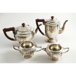 AN ART DECO FOUR-PIECE TEA & COFFEE SET with circular bodies and applied keystone-like detail around