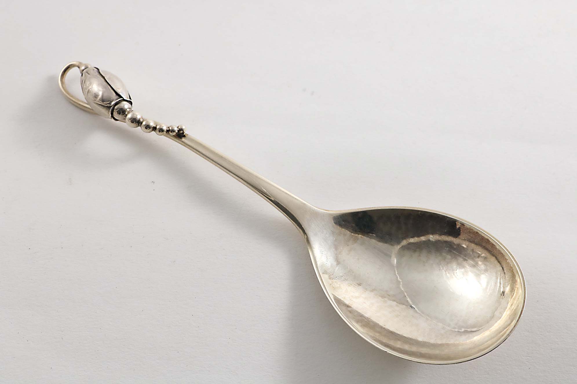 AN EARLY 20TH CENTURY DANISH BLOSSOM PATTERN SERVING SPOON by Georg Jensen, Copenhagen 1930 (