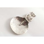 AN EARLY 20TH CENTURY CADDY SPOON with a hammered oval bowl, the stem modelled as the Lincoln Imp,