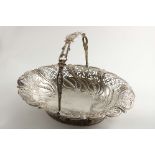 A GEORGE III SWING-HANDLED CAKE BASKET of shaped oval outline with pierced and embossed