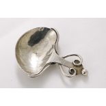 AN ARTS & CRAFTS CADDY SPOON with a heart-shaped bowl with a hammered finish and wire scroll
