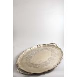 AN EARLY 20TH CENTURY CANADIAN TWO-HANDLED TRAY of shaped oval outline with a moulded border and