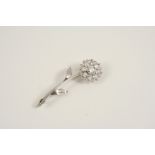 A DIAMOND FOLIATE BROOCH the flowerhead set with old brilliant-cut diamonds within an outer border