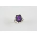 AN ART DECO AMETHYST AND DIAMOND RING the rectangular-shaped amethyst is millegrain set with ten