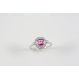 A PINK SAPPHIRE AND DIAMOND CLUSTER RING the octagonal-shaped pink sapphire is set within a surround
