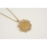 A GOLD SOVEREIGN 1905, in a gold ornate openwork pendant mount, and on a 9ct. gold chain, total