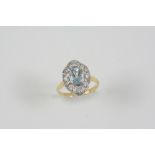 AN AQUAMARINE AND DIAMOND CLUSTER RING the oval-shaped aquamarine is set within an openwork surround