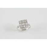 A DIAMOND PLAQUE RING millegrain set with nine old brilliant-cut diamonds and four rose-cut